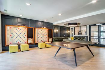 game room with ping pong table and chairs at the district flats apartments